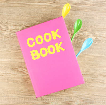 Cookbook and kitchenware on wooden backgroundの写真素材