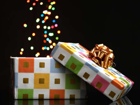 open gift box with bokeh background on blackの写真素材