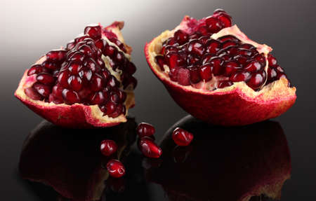 ripe pomegranate fruit on grey backgroundの写真素材