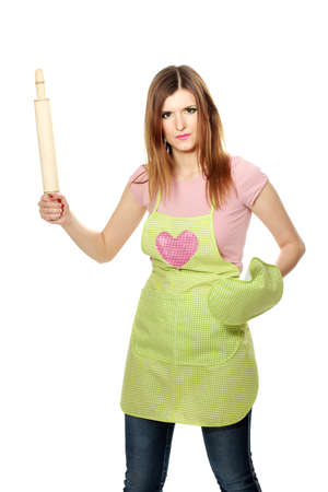 beautiful young housewife with rolling pin isolated on whiteの写真素材