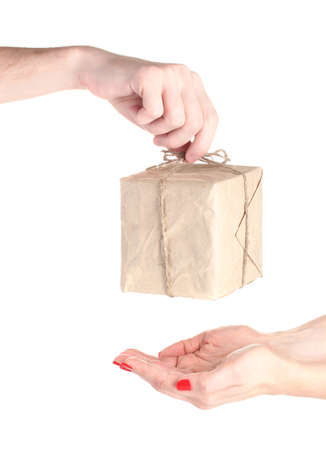Man's hand giving parcel with blank heart-shaped label to woman isolated on whiteの写真素材