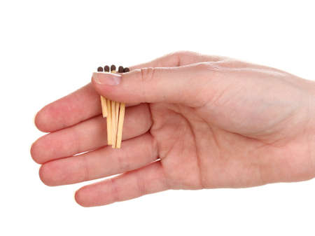 Matches in hand isolated on whiteの写真素材