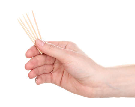 Toothpicks in hand isolated on whiteの写真素材