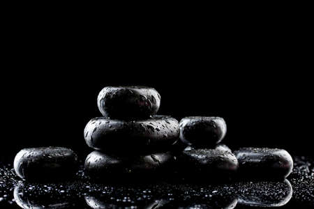 Spa stones with drops on black backgroundの写真素材