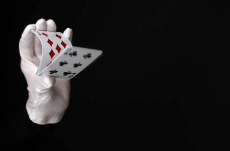 Cards in hand isolated on blackの写真素材