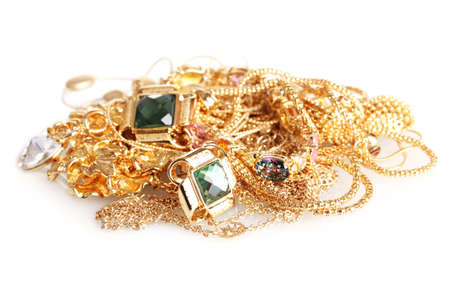 Various gold jewellery isolated on whiteの写真素材