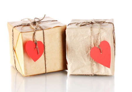 Two small parcels with blank heart-shaped labels isolated on whiteの写真素材