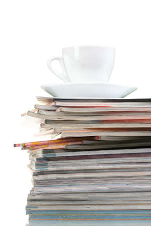 stack of magazines and cup isolated on whiteの写真素材