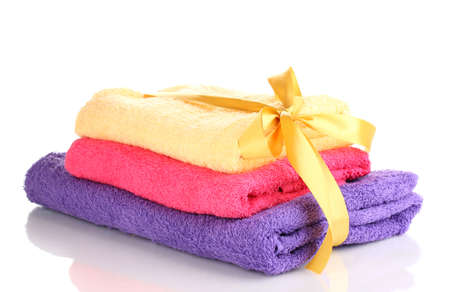Colorful towels with ribbon isolated on whiteの写真素材