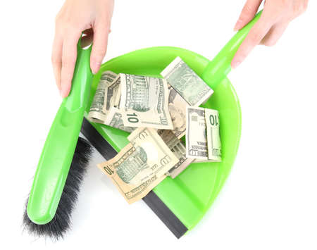 Sweeps money in the shovel on white background close-upの写真素材