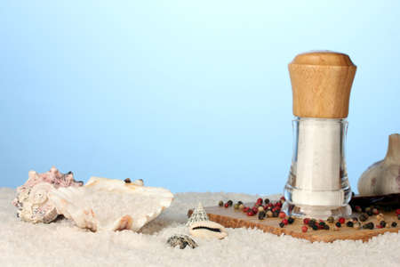 Sea salt on the beach and on the cutting board on a blue backgroundの写真素材
