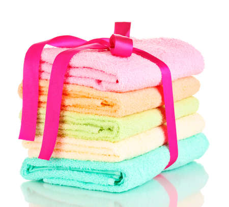 Colorful towels with ribbon isolated on whiteの写真素材