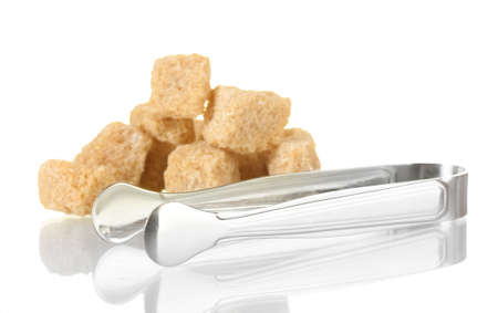 brown cane sugar cubes with sugar-tongs isolated on whiteの写真素材
