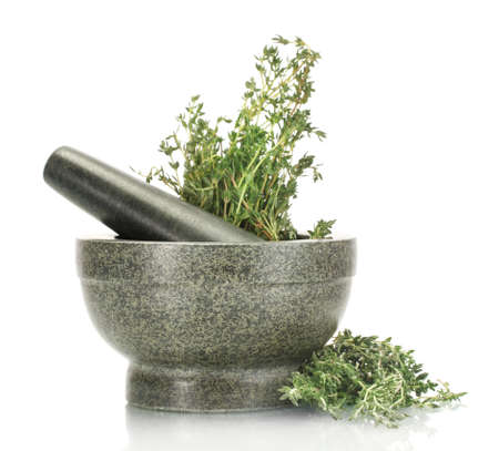 mortar with fresh green thyme isolated on whiteの写真素材
