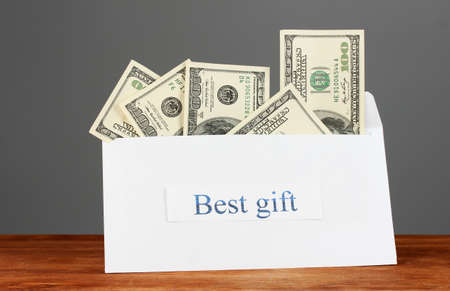 The envelope with the money bills on grey background. Best gift.の写真素材