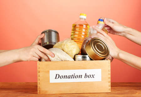 Donation box with food on red background close-upの写真素材