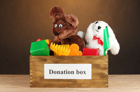 Donation box with children's toys on brown background close-upの写真素材
