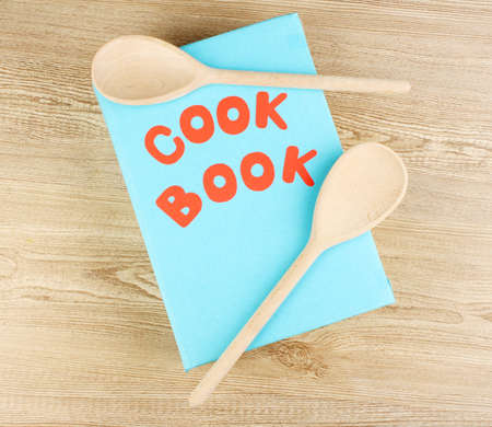 Cookbook and kitchenware on wooden backgroundの写真素材