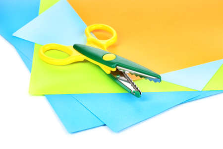 Colorful zigzag scissors with color paper isolated on whiteの写真素材