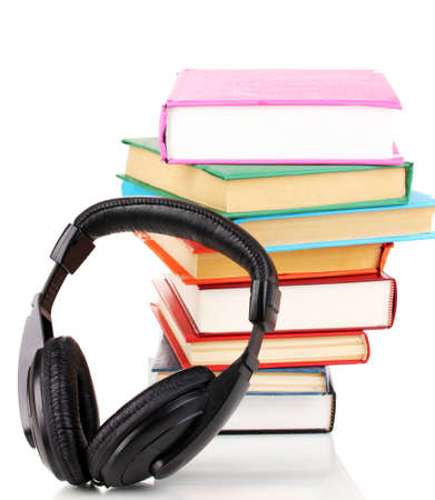 Headphones on books isolated on whiteの写真素材