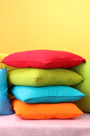 Colorful pillows on yellow backgroundの写真素材