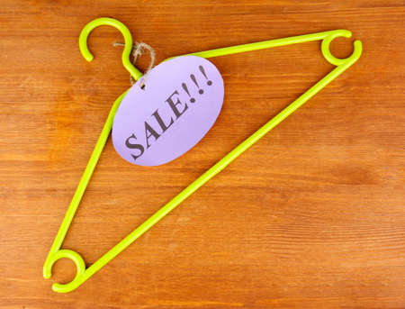 coat hanger with sale tag on wooden backgroundの写真素材