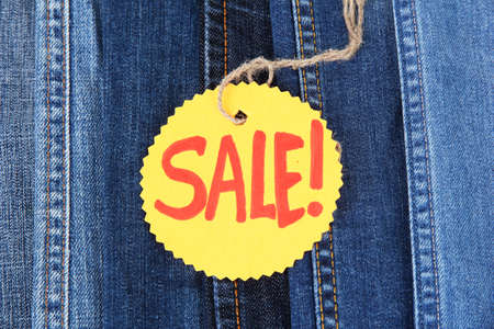 Many jeans with label Sale closeupの写真素材