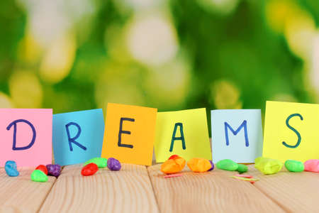 The word Dreams on wooden table on natural backgroundの写真素材