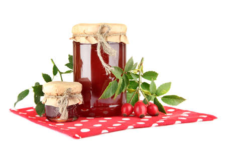 jars with hip roses jam and ripe berries, isolated on whiteの写真素材