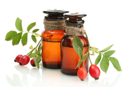 medicine bottles with hip roses, isolated on whiteの写真素材
