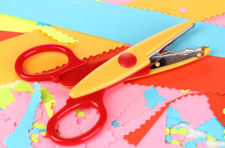 Colorful zigzag scissors on color paper backgroundの写真素材