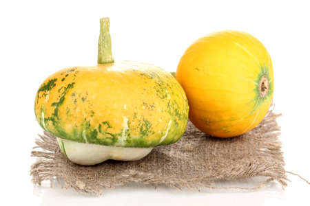 two pumpkins on sackcloth isolated on whiteの写真素材
