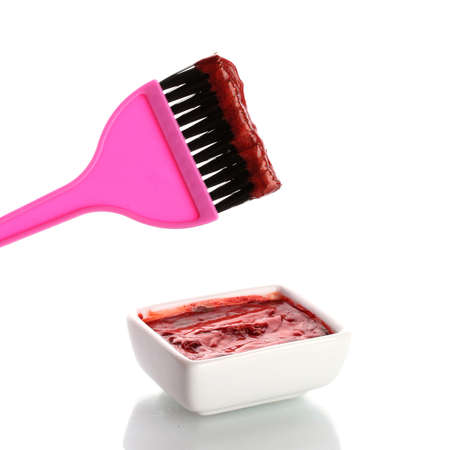Bowl with red hair color and pink brush, on white backgroundの写真素材