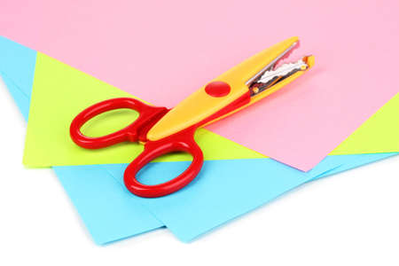 Colorful zigzag scissors with color paper isolated on whiteの写真素材