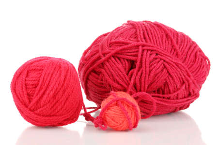 Red knittings yarns isolated on whiteの写真素材