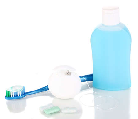 Toothbrush, chewing gum and dental floss isolated on whiteの写真素材