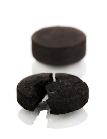 activated carbon in tablets isolated on whiteの写真素材