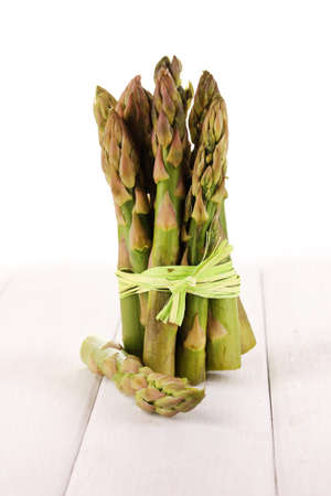 Useful asparagus on wooden table on white backgroundの写真素材