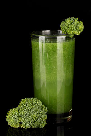 Green vegetable juice in glass isolated on blackの写真素材