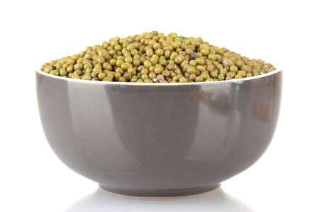 Green mung beans in bowl isolated on whiteの写真素材