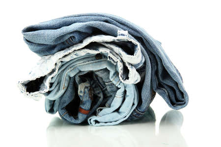 Lot of different blue jeans isolated on whiteの写真素材