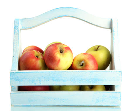 juicy apples in wooden basket, isolated on whiteの写真素材