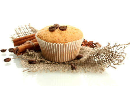 tasty muffin cake on burlap, spices and coffee seeds, isolated on whiteの写真素材