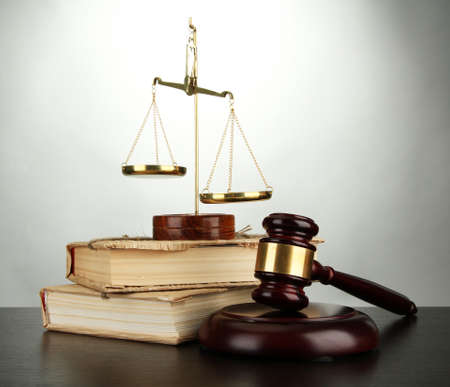 Golden scales of justice, gavel and books on grey backgroundの写真素材