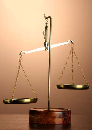 Gold scales of justice on brown backgroundの写真素材