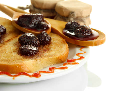 White bread toast with jam on plate, isolated on whiteの写真素材