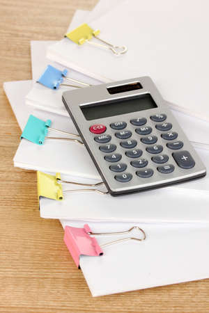 Documents with binder clips on wooden tableの写真素材