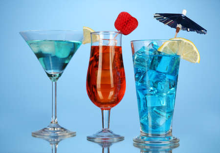 Alcoholic cocktails with ice on blue backgroundの写真素材
