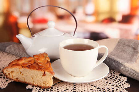 cup of tea with scarf on table in roomの写真素材