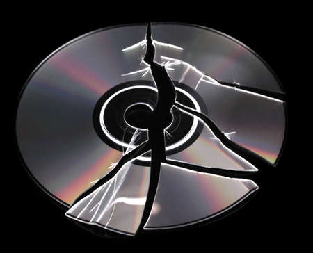 Broken disk with information isolated on blackの写真素材